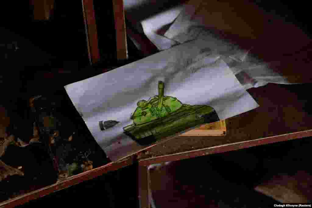 A child&#39;s drawing of a tank is seen among the debris in Oleksandr Melenets&#39; home. The Russian troops who found him asked local residents who he was and covered his body with a tarpaulin. Villagers later buried him on the spot. Serhiy Melenets went missing at about the same time. &nbsp;