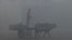 A Pakistani farmer rides cart pulled by a water buffalo along a street amid heavy smog conditions in Lahore. (file photo)