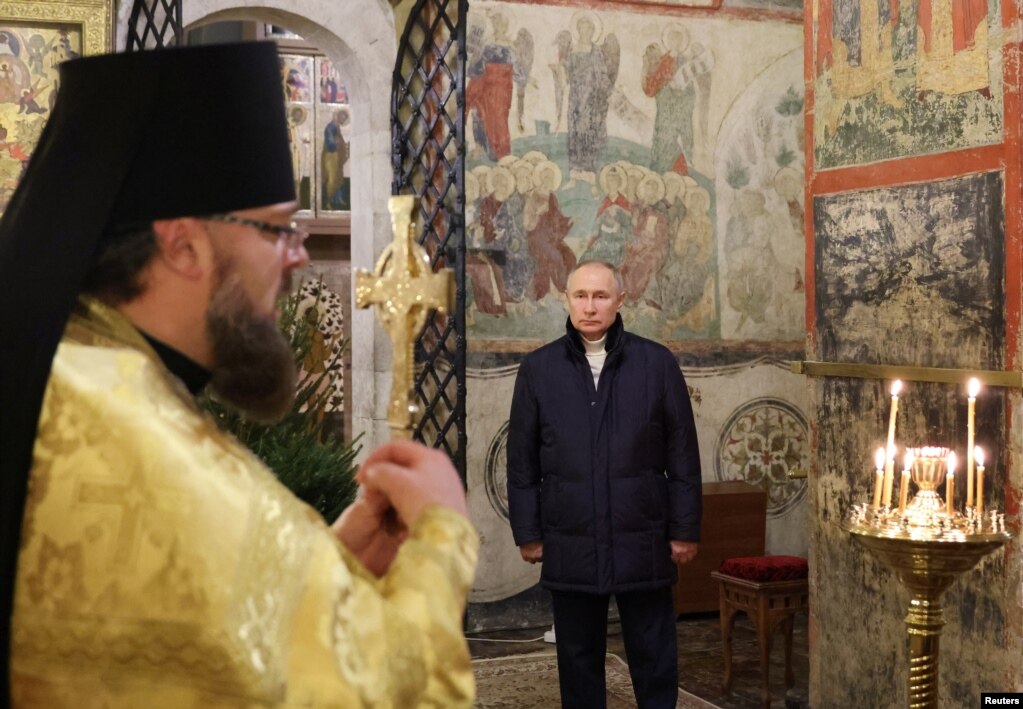 Russian President Vladimir Putin attends the Orthodox Christmas service at the Kremlin in Moscow on January 7.