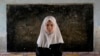 Eight-year-old Mahtab poses in her classroom at the Abdul Rahim Shaheed School in Kabul on April 23. After seizing power in August 2021, the Taliban banned high school education for girls.