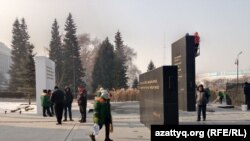 Работники ремонтирует мемориал Тагзым в Алматы, посвящённый Январским событиям. 26 декабря 2022 года