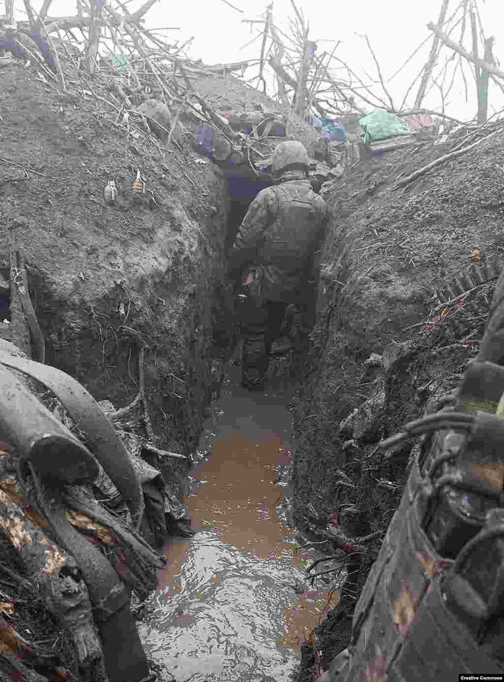 A Ukrainian soldier in a mud-filled trench reportedly near Bakhmut, in eastern Ukraine, in November.