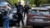 Police officers stand the Ukrainian Embassy in Madrid after a blast injured one employee while handling a letter on November 30.