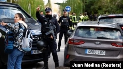 Police stand outside the Ukrainian Embassy in Madrid after a blast injured one employee while handling a letter on November 30.