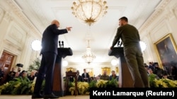 U.S. President Joe Biden (left) and Ukrainian President Volodymyr Zelenskiy hold a joint news conference in the East Room of the White House in Washington on December 21.