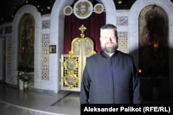 Priest Andriy Dudchenko stands in the Savior-Transfiguration Cathedral in Kyiv.