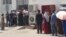 Turkmen line up for subsidized food at a state store. (file photo)
