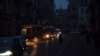 Vehicles drive in darkness in the center of Lviv, one of several Ukrainian cities that have experienced power outages this week as a result of Russian strikes on the country's infrastructure. 