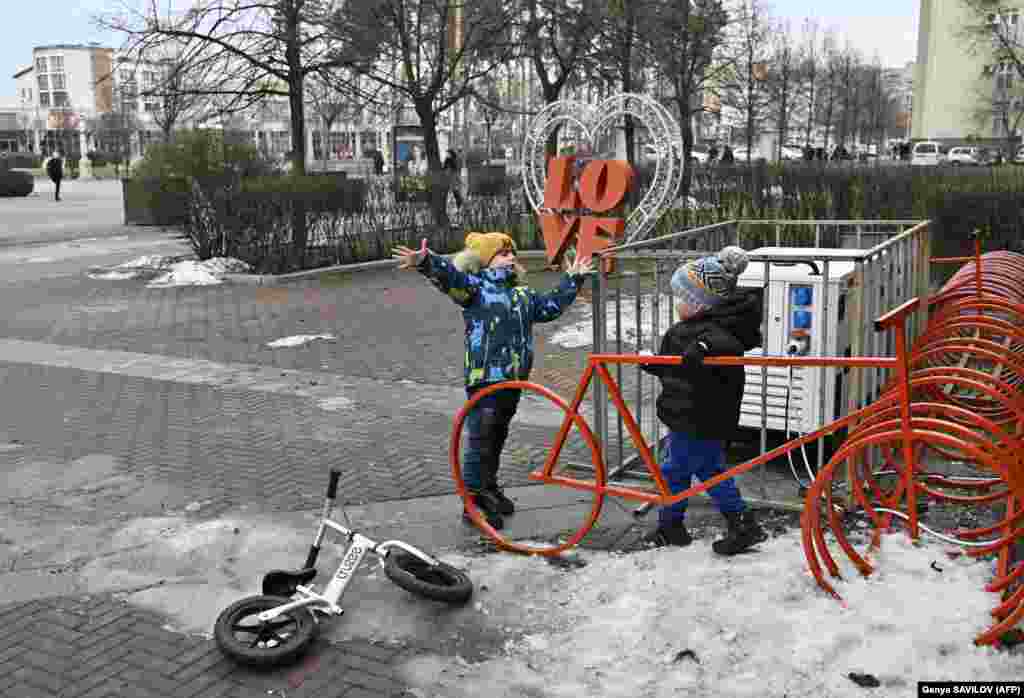 Children play near a generator in front of the library. Ukrainian officials have tried to encourage Irpin on its road to recovery by designating it a &quot;hero city,&quot; an acknowledgement of the resolve its people have demonstrated in the face of so much adversity.