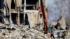 Workers clear the site following an attack by Ukrainian forces on a barracks where the Russian soldiers were stationed in Makiyivka, Donetsk region, on January 3.