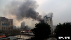 Smoke billows from a Chinese-owned hotel in Kabul following a bomb attack in the Afghan capital on December 12. 