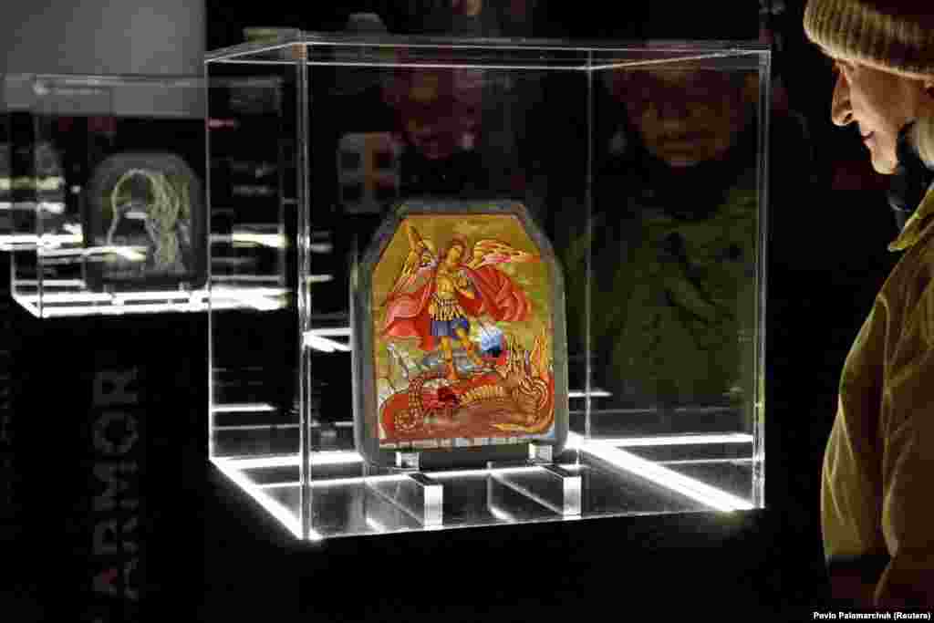 This icon of St. George slaying the dragon was painted on a piece of body armor taken from a Ukrainian soldier whose life was reportedly saved by the plate. Ballistic damage from two projectiles can be seen at the dragon&#39;s mouth and belly. The unique artwork is part of an exhibition called ArtArmor&nbsp;that opened in Ukraine&#39;s western city of Lviv on December 27.&nbsp;