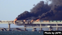 Black smoke billows from an explosion on the Kerch Bridge that links Crimea to Russia on October 8, 2022.