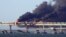 Black smoke billows from an explosion on the Kerch Bridge that links Crimea to Russia on October 8, 2022.