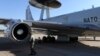 A NATO officer inspects an AWACS aircraft as it prepares to take off for a training mission. (file photo)