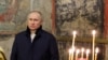 Russian President Vladimir Putin attends an Orthodox Christmas mass at the Kremlin on January 6.