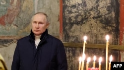 Russian President Vladimir Putin attends an Orthodox Christmas mass at the Kremlin on January 6.