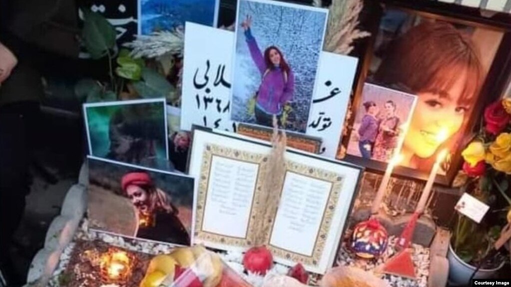 Mourners laid photos and other tributes on December 21 on the grave of Ghazale Chalabi, who was shot in the head by security forces during a protest on September 27 in Amol, Iran.