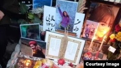 Mourners laid photos and other tributes on December 21 on the grave of Ghazale Chalabi, who was shot in the head by security forces during a protest on September 27 in Amol, Iran.