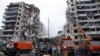 UKRAINE – Emergency personnel work at the site where an apartment block was heavily damaged by a Russian missile strike, amid Russia's attack on Ukraine, in Dnipro, January 15, 2023
