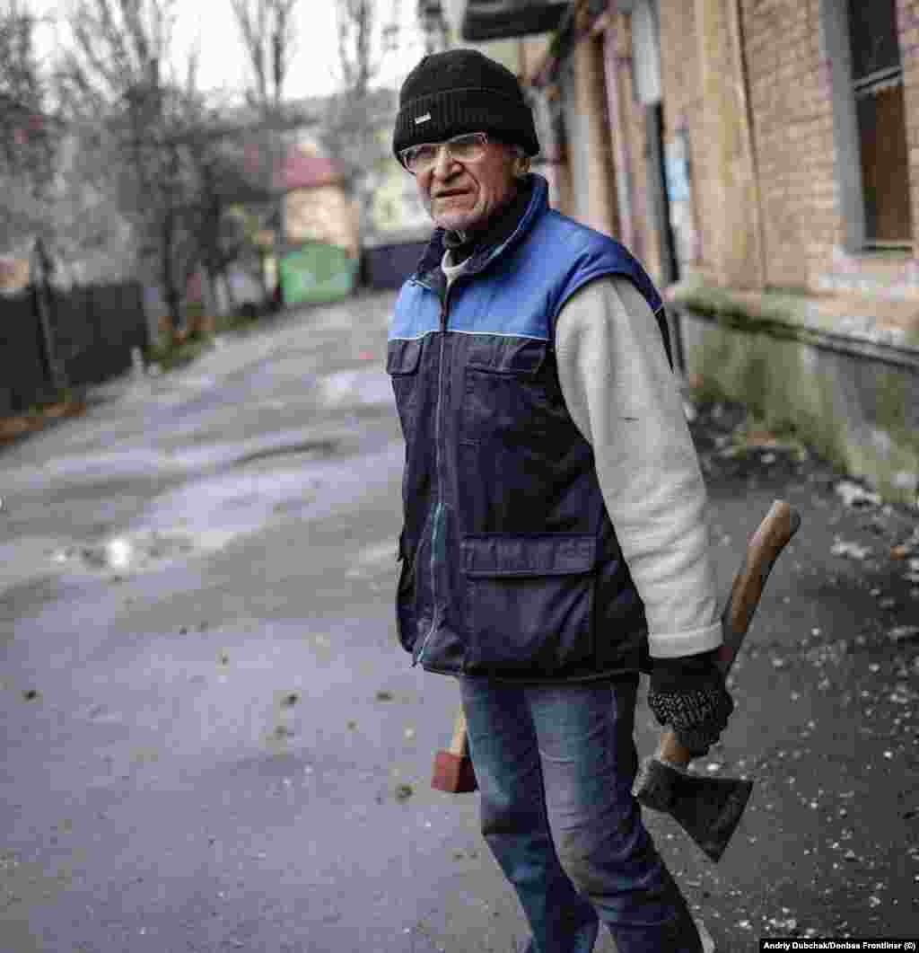 A civilian with axes in Bakhmut. Residents are using trees for heating and to cook food in the frontline city. In a post on social media, photographer Andriy Dubchak says explosions are heard &ldquo;every minute&rdquo; in central Bakhmut.&nbsp;