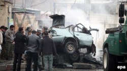 Afghan security officials inspect the site of a bomb blast in Kabul on January 13.