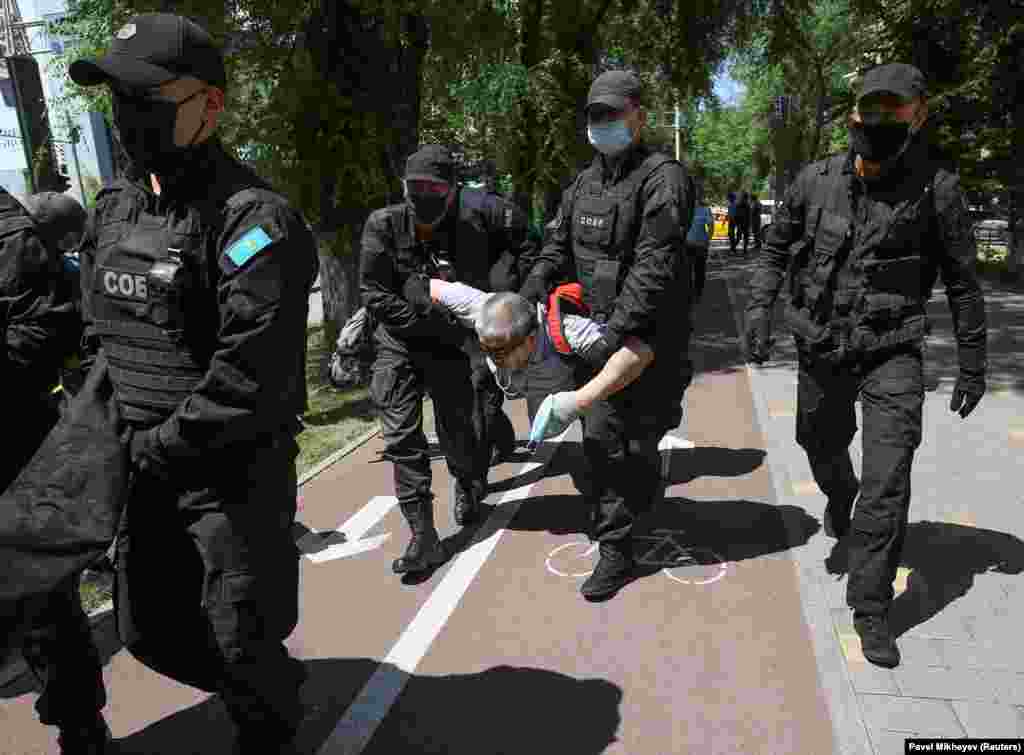 Kazakh police detain a man during an unsanctioned rally in Almaty.