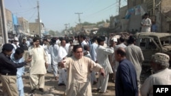 Local Pakistani residents gather at the site of a bomb blast in Sibi, some 180 kilometres southeast of Quetta. At least 10 people died in the explosion.