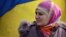 Ukraine - A Crimean Tatar woman stands by a Ukrainian flag as pro-Ukrainian demonstrators march in the streets of Simferopol in support of the Crimean Tatar community, on March 14, 2014