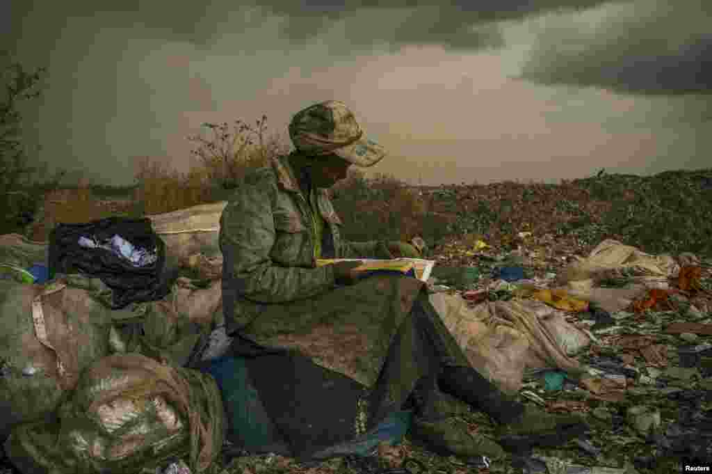 Micah Albert of the United States, a photographer working for Redux Images, won first prize in the Contemporary Issues Single category with this picture of a woman pausing in the rain as she works as a trash picker at a 30-acre dump in Nairobi, Kenya.