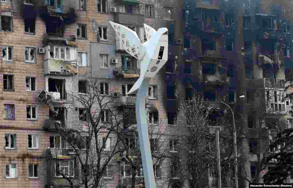 A lamp pole in the shape of a dove located in Freedom Square near a block of flats heavily damaged by Russian shelling in the southern port city of Mariupol.