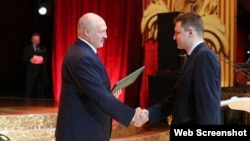 Belarusian strongman Aleyaksandr Lukashenka (left) presents an award to Syarhey Adzyarykha in 2020. 