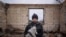 Ukraine War n-- Danyk Rak, 12, holds a cat standing on the debris of his house destroyed by Russian forces' shelling in the outskirts of Chernihiv, Ukraine, Wednesday, April 13, 2022.