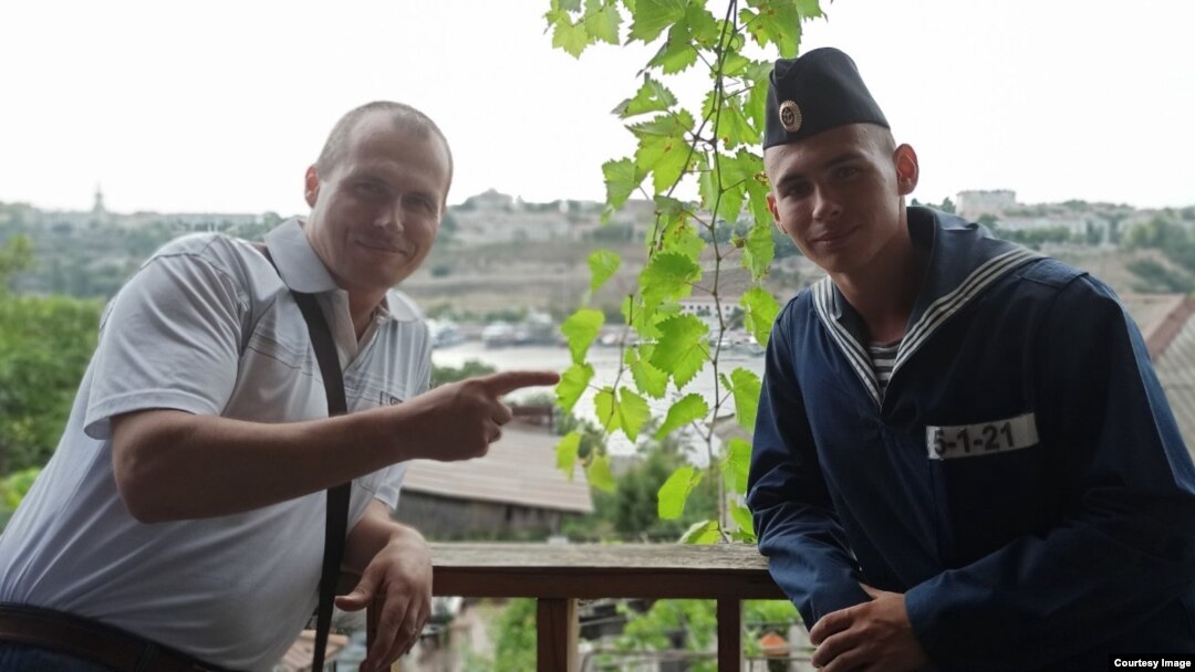 Dmitry Shkrebets (left) with his son, Yegor, who has been "missing" since Russia's Moskva battleship sank in the Black Sea in April. 