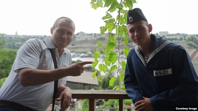 Dmitry Shkrebets (left) with his son, Yegor, who has been "missing" since Russia's Moskva battleship sank in the Black Sea in April. 