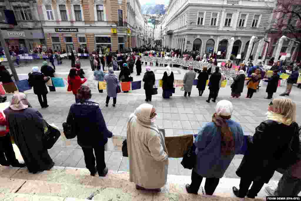 Women in the Bosnian capital, Sarajevo, take part in an event to commemorate the Srebrenica massacre.