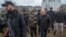 International Criminal Court prosecutor Karim Khan (2nd right) and Ukrainian Prosecutor-General Iryna Venediktova visit the site of a mass grave in the town of Bucha, outside Kyiv, on April 13.
