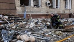 Un pompier se odihnește în fața ruinelor unei clădiri care a fost bombardată de ruși. Harkov, nord-est, al doilea oraș ca mărime în Ucraina 