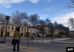 Dark smoke rises following an air strike in the western Ukrainian city of Lviv on April 18.