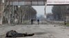 The body of a civilian killed during Russia's assault lies on a street in the devastated southern port city of Mariupol on April 15.