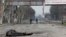 The body of a civilian killed during Russia's assault lies on a street in the devastated southern port city of Mariupol on April 15.
