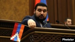 Armenia - Pro-government parliamentarian Vahagn Aleksanian removes a Karabakh flag from the parliament rostrum, April 12, 2022.