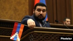 Armenia - Pro-government parliamentarian Vahagn Aleksanian removes a Karabakh flag from the parliament rostrum, April 12, 2022.