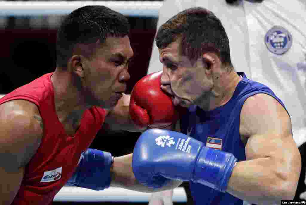 The Phillippines&#39; Eumir Felix Marcial (left) and Uzbekistan&#39;s Israil Madrimov fight in their men&#39;s middleweight boxing semifinal at the 18th Asian Games in Jakarta, Indonesia. Marcial lost in a split decision. (AP/Lee Jin-man)