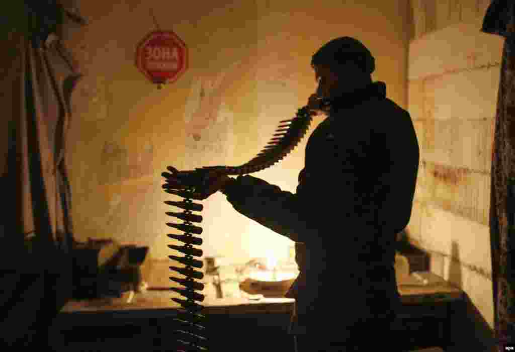 A Ukrainian serviceman prepares ammunition during combat with pro-Russia rebels in an industrial area near the village of Avdiyivka in the Donbas region on November 22 (epa/Anatolii Stepanov).