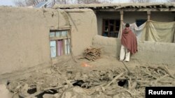 An Afghan man stands on the roof of a house damaged in an air strike in Nangarhar Province on February 21.