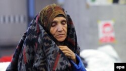 FILE: An Afghan refugee sits at a refugee processing centre at the main train station in Vienna, Austria.