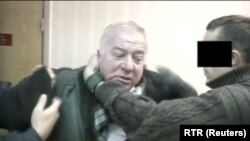 A still image taken from an undated video shows Sergei Skripal, a former colonel of Russia's GRU military intelligence service, being detained by secret service officers in an unknown location.