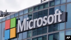 FILE - This April 12, 2016 file photo shows the Microsoft logo in Issy-les-Moulineaux, outside Paris, France. 
