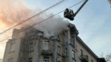 Ukrainian firefighters extinguish a fire in a residential building in Kyiv following a Russian drones attack on January 1. 